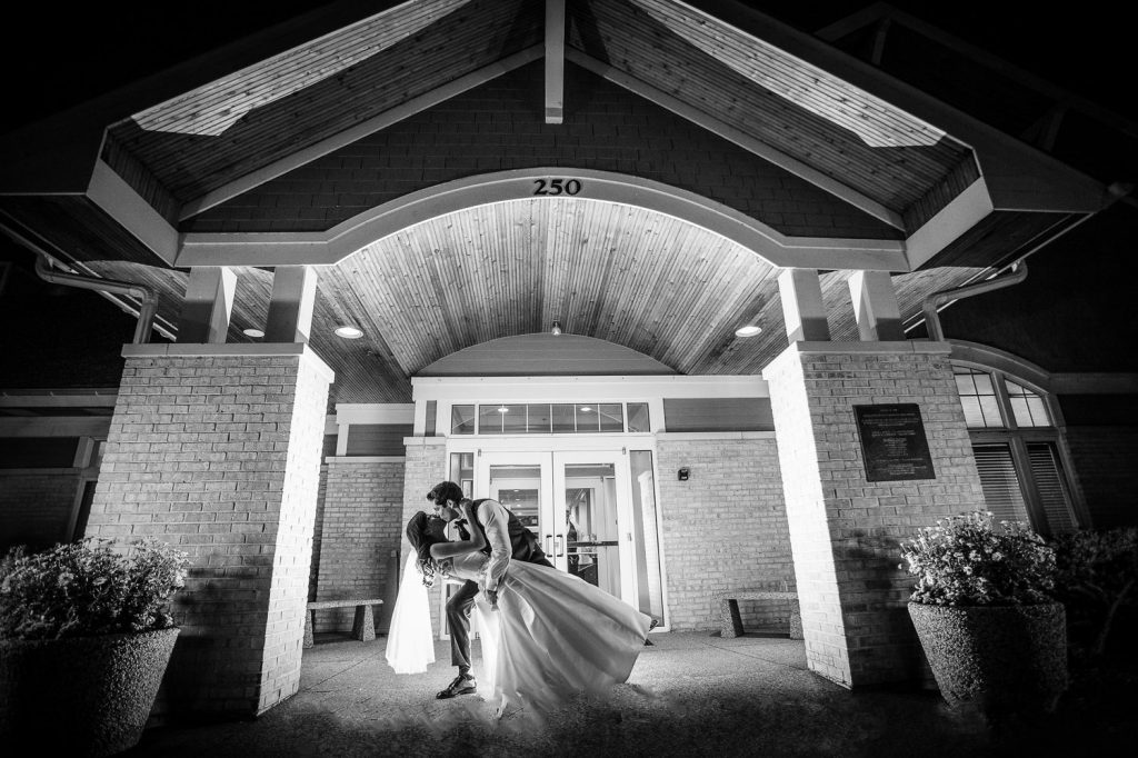 Bride and groom in front of clubhouse at night. Weddings at White Deer Run Golf Club Vernon Hills, Illinois.
